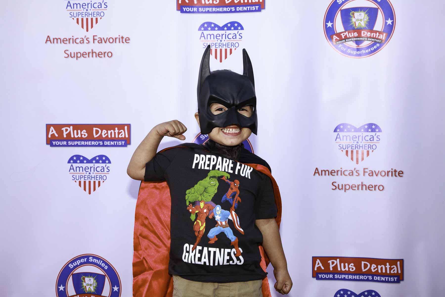 A young patient dressed as a superhero at an A Plus Dental community event